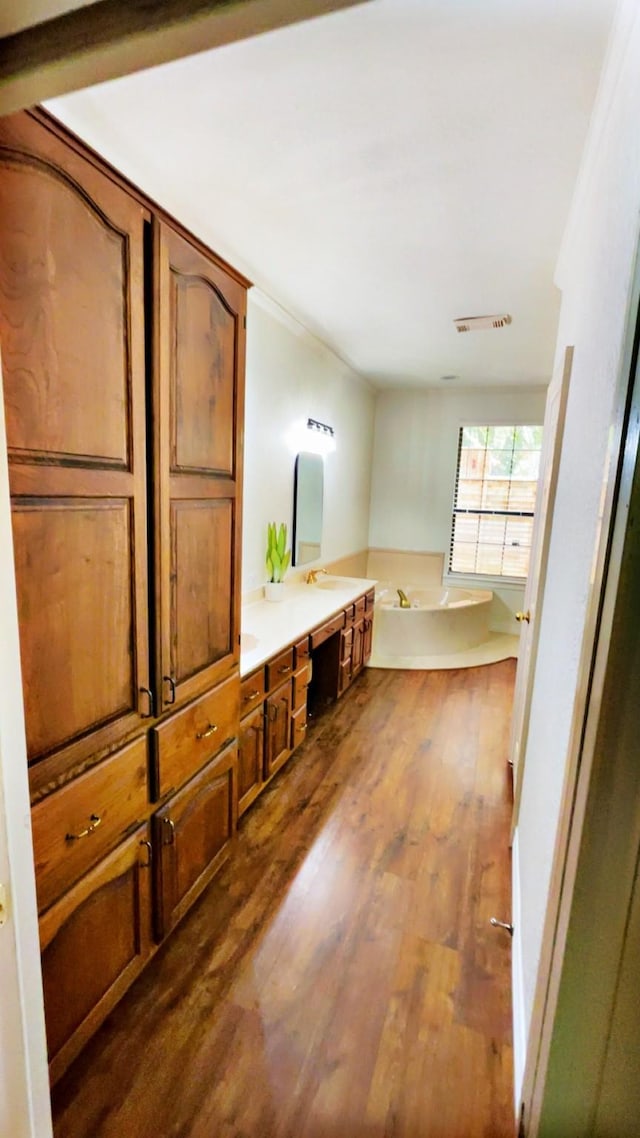 1600 Azalea St, Sweeny, TX 77480 - bathroom with wood finished floors, a garden tub, and double vanity