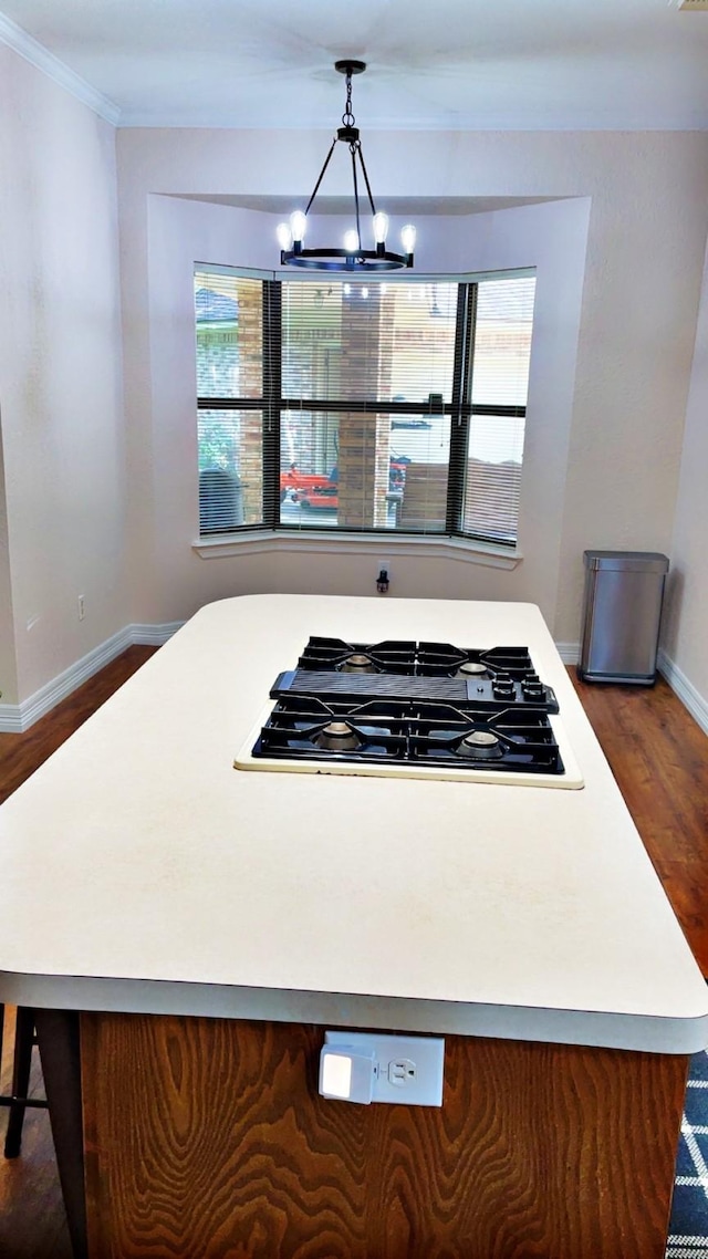 1600 Azalea St, Sweeny, TX 77480 - kitchen with dark wood finished floors, black gas stovetop, a chandelier, crown molding, and light countertops