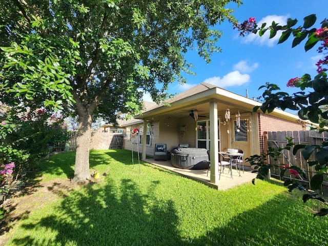 3514 Tulip Trace Dr, Spring, TX 77386 - rear view of property featuring a ceiling fan, a patio area, a fenced backyard, and a hot tub