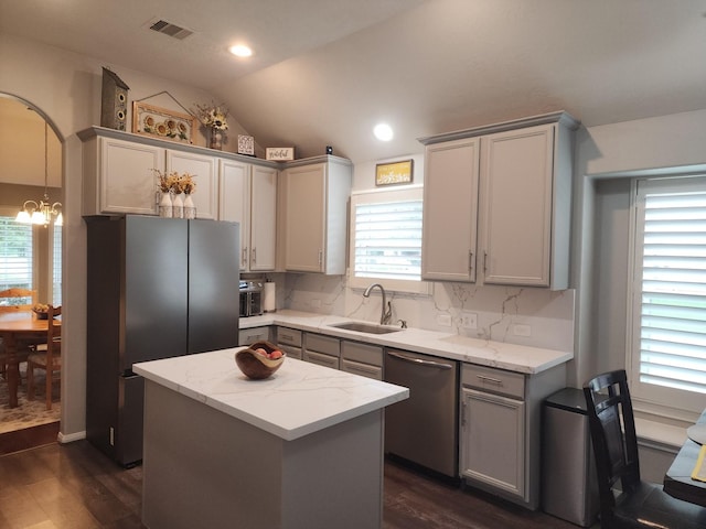 3514 Tulip Trace Dr, Spring, TX 77386 - kitchen with stainless steel appliances, a chandelier, dark wood-style floors, gray cabinetry, and vaulted ceiling