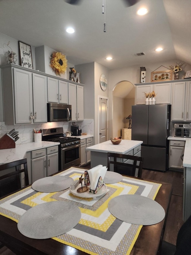 3514 Tulip Trace Dr, Spring, TX 77386 - kitchen with appliances with stainless steel finishes, arched walkways, gray cabinetry, light countertops, and recessed lighting