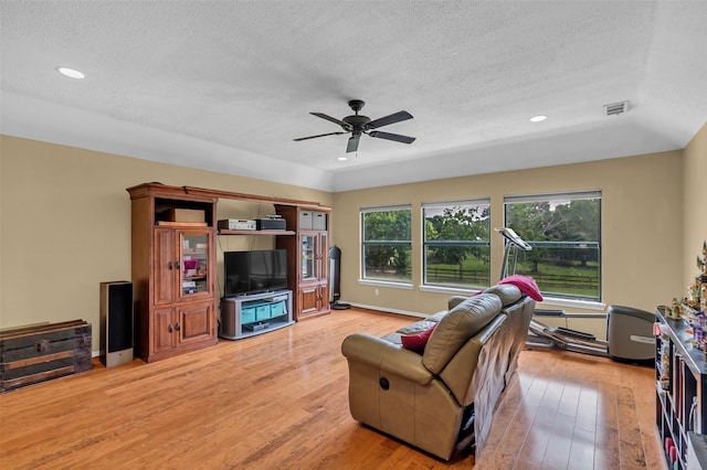 1019 Towering Oaks St, Magnolia, TX 77355 - living area featuring a textured ceiling, light wood-style flooring, ceiling fan, and recessed lighting