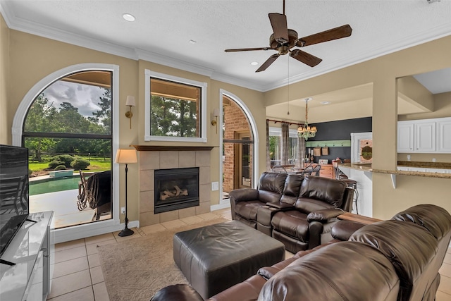 1019 Towering Oaks St, Magnolia, TX 77355 - living room with ceiling fan, a fireplace, light tile patterned floors, recessed lighting, and a chandelier
