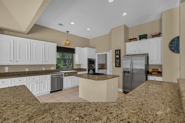 1019 Towering Oaks St, Magnolia, TX 77355 - kitchen with appliances with stainless steel finishes, dark stone counters, white cabinetry, light tile patterned flooring, and a center island