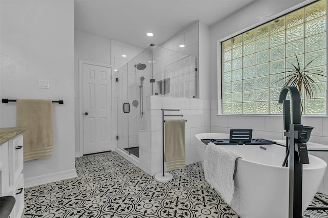 1019 Towering Oaks St, Magnolia, TX 77355 - full bathroom featuring a shower stall, vanity, a freestanding tub, tile walls, and recessed lighting