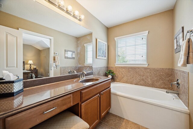 11014 Bakerwood Dr, Houston, TX 77064 - ensuite bathroom featuring a garden tub, tile patterned floors, and vanity
