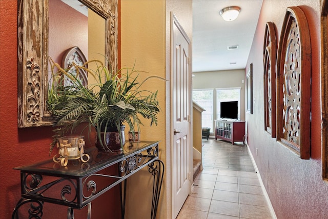 11014 Bakerwood Dr, Houston, TX 77064 - corridor with a textured wall and light tile patterned floors
