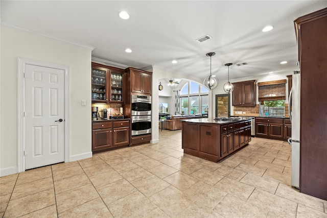 12415 Bunker Cove Dr, Cypress, TX 77433 - kitchen with decorative backsplash, recessed lighting, appliances with stainless steel finishes, dark brown cabinets, and crown molding