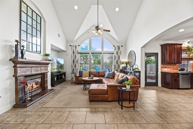 12415 Bunker Cove Dr, Cypress, TX 77433 - living area with a glass covered fireplace, ceiling fan, arched walkways, and high vaulted ceiling
