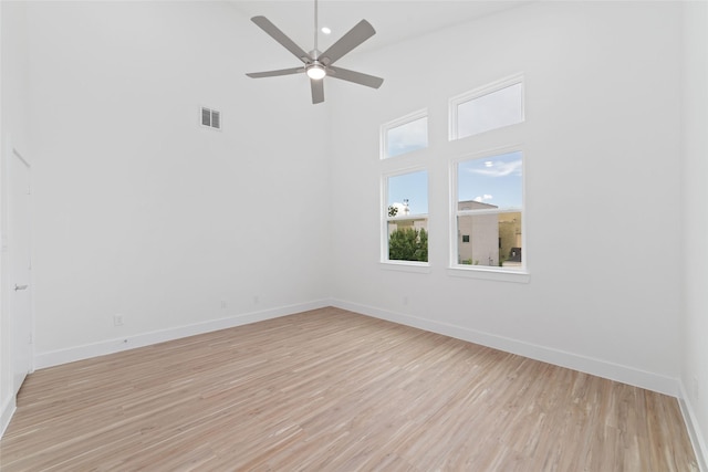 2103 Holman, Houston, TX 77004 - spare room featuring a high ceiling, light wood-type flooring, and a ceiling fan