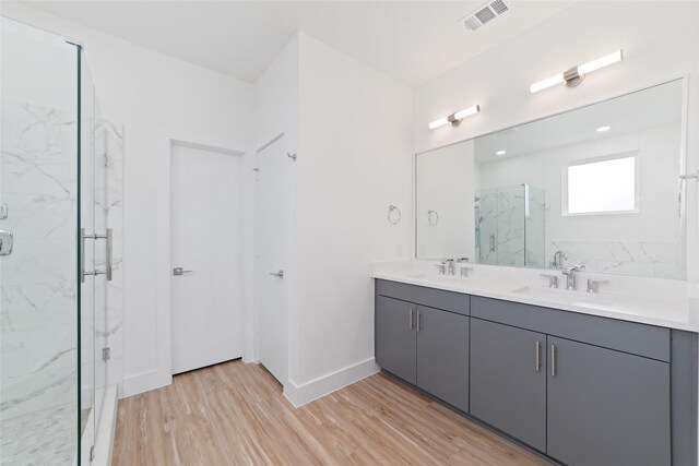 2103 Holman, Houston, TX 77004 - full bath featuring a marble finish shower, wood finished floors, and double vanity
