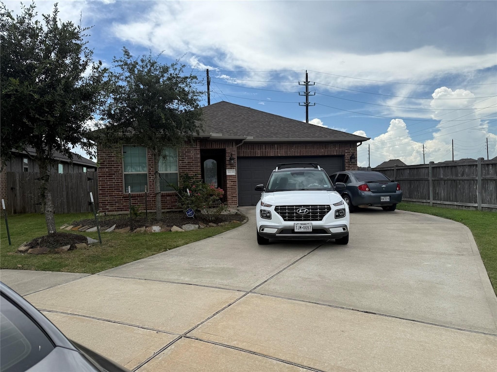 18239 Alora Springs Trce, Cypress, TX 77433 - ranch-style home featuring an attached garage, driveway, brick siding, and a shingled roof