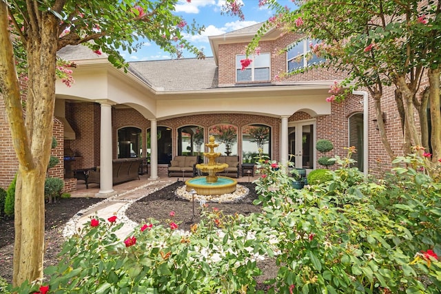 15611 Oyster Cove Dr, Sugar Land, TX 77478 - rear view of house featuring a patio, brick siding, and roof with shingles