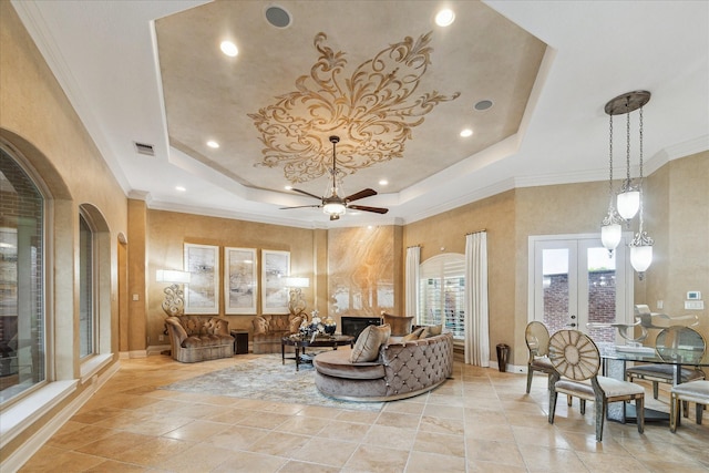15611 Oyster Cove Dr, Sugar Land, TX 77478 - living room with a tray ceiling, arched walkways, ornamental molding, a ceiling fan, and french doors