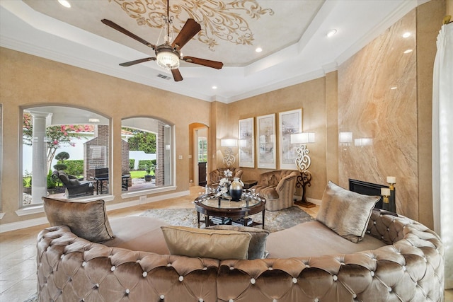 15611 Oyster Cove Dr, Sugar Land, TX 77478 - living area featuring a tray ceiling, ceiling fan, recessed lighting, arched walkways, and crown molding