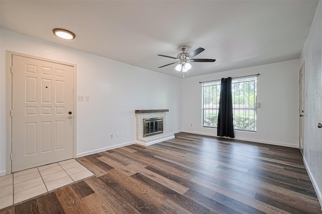2110 Wilcrest Dr Unit 140, Houston, TX 77042 - unfurnished living room with dark wood-type flooring, a ceiling fan, and a fireplace