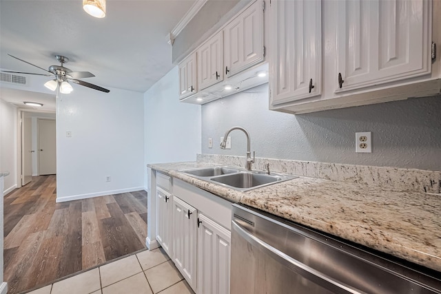 2110 Wilcrest Dr Unit 140, Houston, TX 77042 - kitchen with stainless steel dishwasher, light countertops, a ceiling fan, and white cabinetry