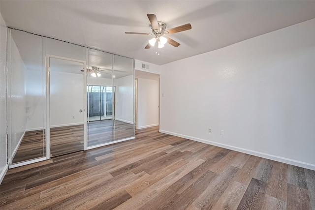 2110 Wilcrest Dr Unit 140, Houston, TX 77042 - unfurnished bedroom featuring wood finished floors, a ceiling fan, and a closet