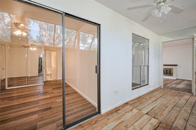 2110 Wilcrest Dr Unit 140, Houston, TX 77042 - unfurnished sunroom featuring a ceiling fan and a brick fireplace