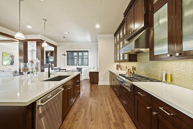 959 W 42nd St, Houston, TX 77018 - kitchen featuring stainless steel appliances, dark wood-style flooring, light countertops, ornamental molding, and decorative light fixtures
