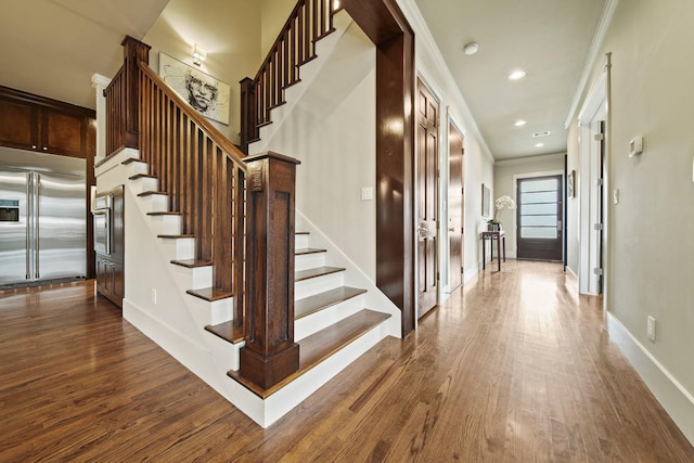 959 W 42nd St, Houston, TX 77018 - staircase featuring wood finished floors, ornamental molding, and recessed lighting