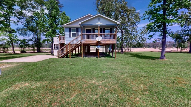 25531 Black St, Splendora, TX 77372 - coastal inspired home with a porch, stairway, and a front lawn