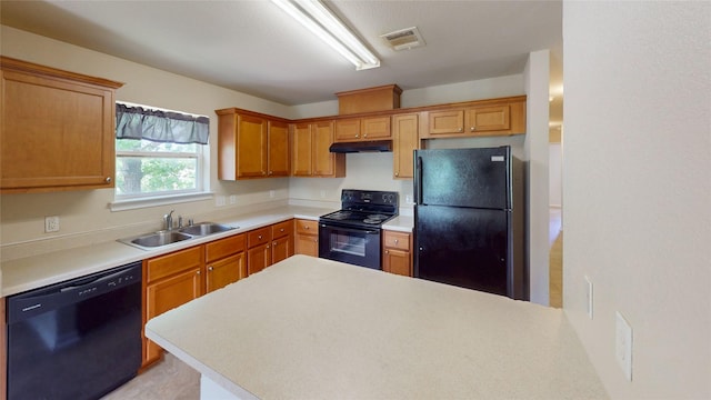 25531 Black St, Splendora, TX 77372 - kitchen featuring black appliances, under cabinet range hood, light countertops, and a peninsula