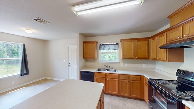 25531 Black St, Splendora, TX 77372 - kitchen featuring black appliances, under cabinet range hood, light countertops, and brown cabinetry
