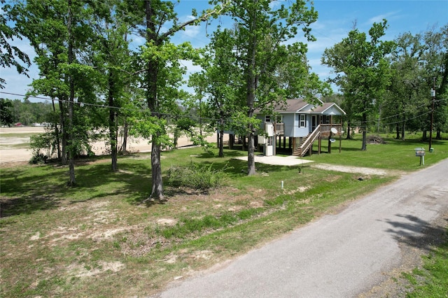 25531 Black St, Splendora, TX 77372 - view of front of property featuring stairway and a front lawn