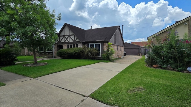 4531 Hickory Downs Dr, Houston, TX 77084 - tudor home with a front lawn, brick siding, and a detached garage