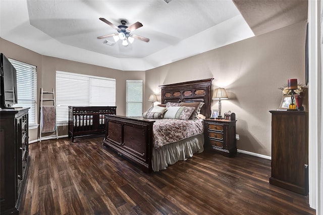 5806 Wilton St, Pearland, TX 77584 - bedroom featuring dark wood-type flooring, a raised ceiling, and a ceiling fan