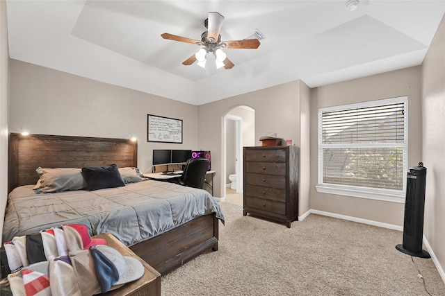 5806 Wilton St, Pearland, TX 77584 - bedroom with arched walkways, light colored carpet, a tray ceiling, and a ceiling fan
