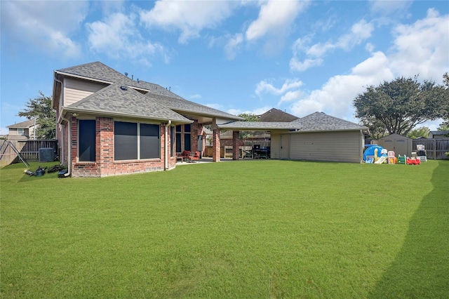 5806 Wilton St, Pearland, TX 77584 - rear view of property with a storage shed, brick siding, a patio, and roof with shingles