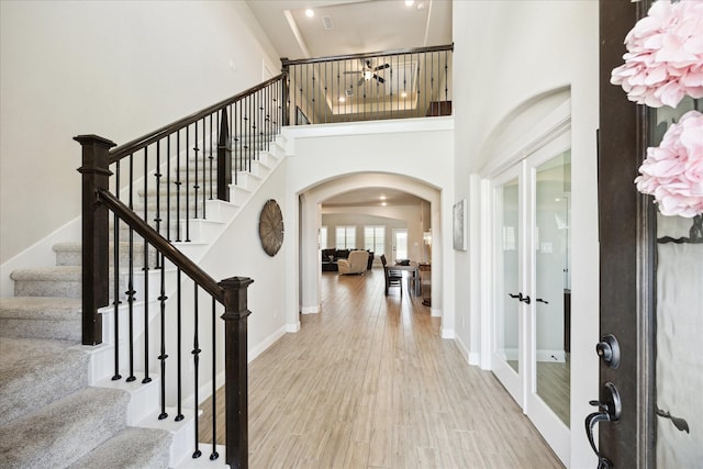 508 Buckhorn St, Sealy, TX 77474 - foyer with arched walkways, french doors, stairway, wood finished floors, and a high ceiling