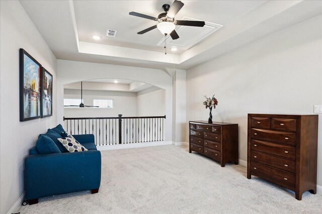 508 Buckhorn St, Sealy, TX 77474 - living area featuring ceiling fan, a raised ceiling, carpet flooring, and arched walkways