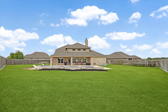 508 Buckhorn St, Sealy, TX 77474 - rear view of house with a chimney, a patio area, brick siding, a fenced backyard, and roof with shingles