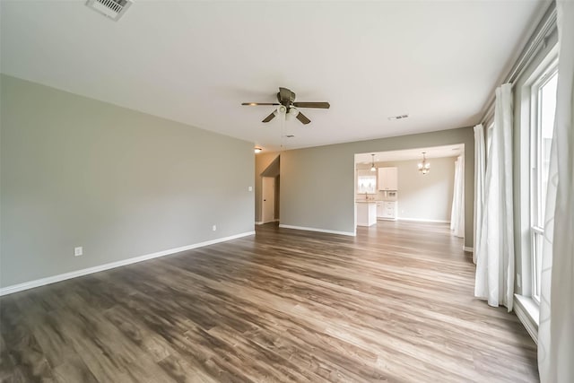 6219 Summerville Ln, Houston, TX 77041 - empty room with a chandelier, a ceiling fan, wood finished floors, and plenty of natural light