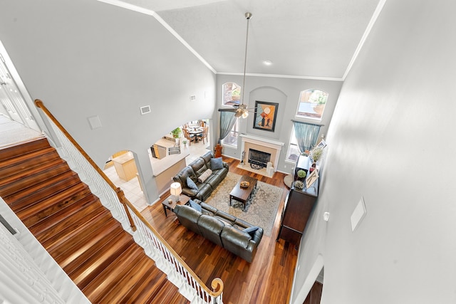 12815 Mimosa Spring Dr, Tomball, TX 77377 - living room featuring ceiling fan, a fireplace, crown molding, wood finished floors, and stairway