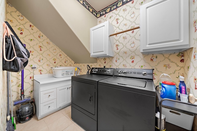 12815 Mimosa Spring Dr, Tomball, TX 77377 - laundry area featuring cabinet space, washer and dryer, and light tile patterned floors