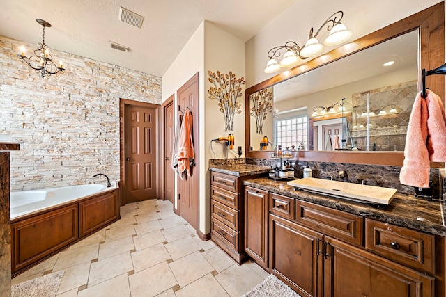 12815 Mimosa Spring Dr, Tomball, TX 77377 - full bathroom featuring vanity, a garden tub, tile patterned flooring, a chandelier, and a textured ceiling