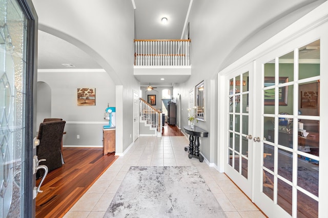 12815 Mimosa Spring Dr, Tomball, TX 77377 - tiled entryway featuring arched walkways, french doors, stairway, ornamental molding, and ceiling fan