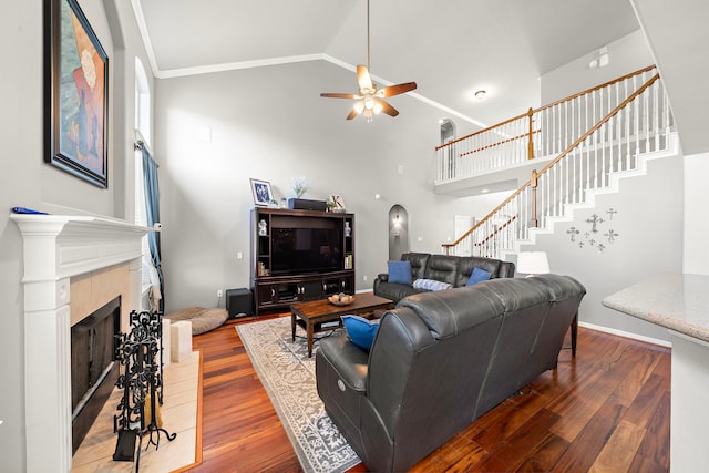 12815 Mimosa Spring Dr, Tomball, TX 77377 - living area with high vaulted ceiling, stairway, wood finished floors, a ceiling fan, and a tile fireplace