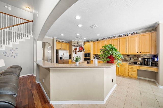 12815 Mimosa Spring Dr, Tomball, TX 77377 - kitchen with stainless steel appliances, a large island, arched walkways, tasteful backsplash, and recessed lighting