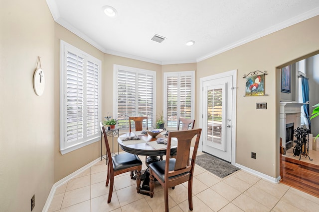 12815 Mimosa Spring Dr, Tomball, TX 77377 - dining room with ornamental molding, light tile patterned flooring, recessed lighting, and a fireplace