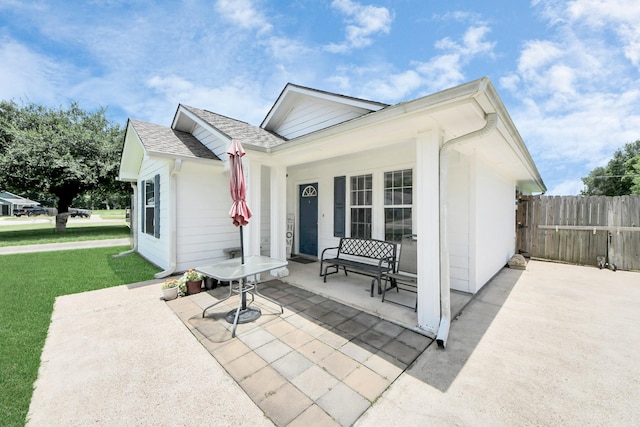 1214 Robert St, Baytown, TX 77521 - rear view of house with a porch and a shingled roof