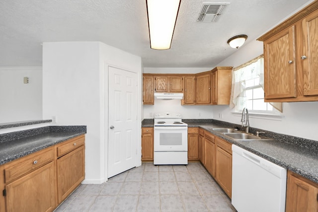 1214 Robert St, Baytown, TX 77521 - kitchen with white appliances, under cabinet range hood, brown cabinets, and dark countertops