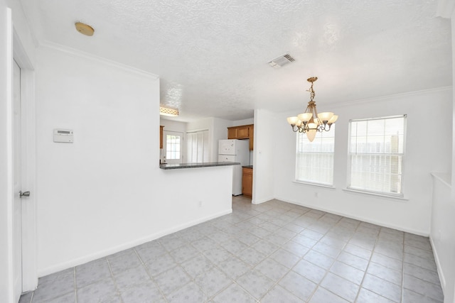 1214 Robert St, Baytown, TX 77521 - empty room with a chandelier, a textured ceiling, and ornamental molding