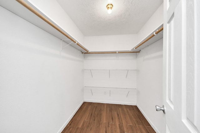 1214 Robert St, Baytown, TX 77521 - walk in closet with dark wood-style flooring