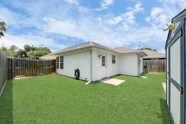 1214 Robert St, Baytown, TX 77521 - back of house featuring a fenced backyard and a shingled roof