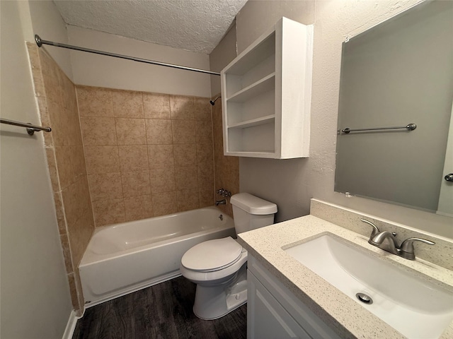 3616 Longwood Dr, Pasadena, TX 77503 - bathroom with bathtub / shower combination, wood finished floors, vanity, and a textured ceiling